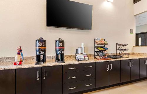 a kitchen counter with a television on a wall at Extended Stay America Suites - Buffalo - Airport in Buffalo
