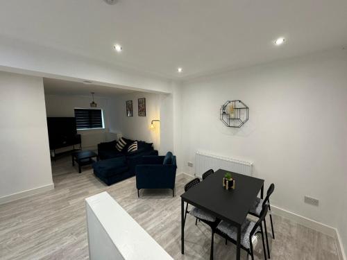 a living room with a couch and a table at Luna Apartments Ashington in Ashington