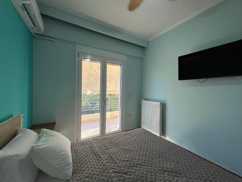 a bedroom with a bed and a large window at Joyful Guest Houses by 8essentially in Chania Town