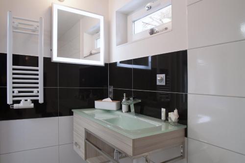 a bathroom with a sink and a mirror at Designpension Idyll Nr2 Hotel Garni in Wernigerode