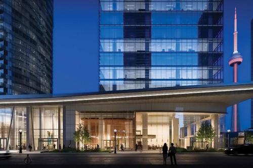 a large building with people standing in front of it at Delta Suites - In Downtown Toronto, Opposite Scotiabank Arena, CN Tower, Rogers Centre & MTCC in Toronto
