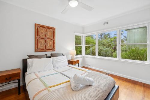 a bedroom with a bed and two windows at Surphy G in Anglesea