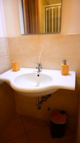 a white sink in a bathroom with a mirror at C'era una volta in Anagni