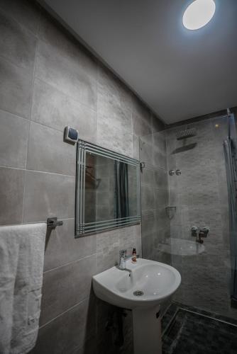 a bathroom with a sink and a shower at Hotel Arabesque in Rabat