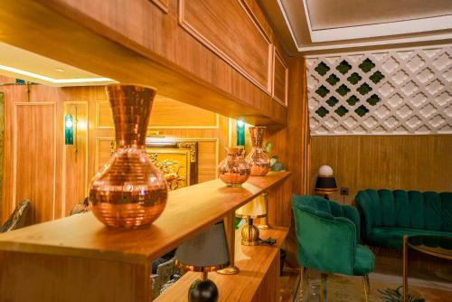 a room with several vases on a wooden counter at Hotel Arabesque in Rabat