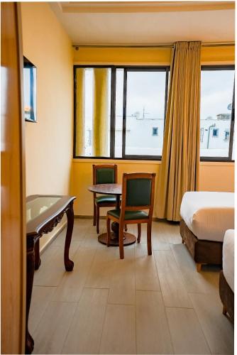 a hotel room with a pool table and a desk at Hotel Arabesque in Rabat