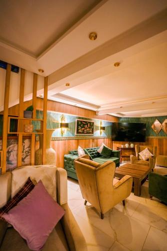 a living room with a couch and a chair at Hotel Arabesque in Rabat