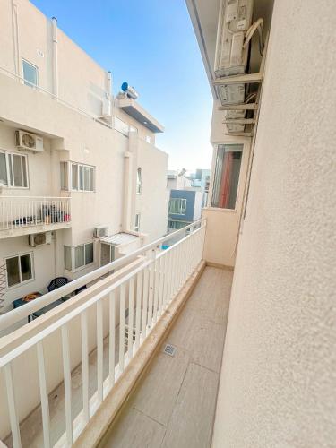 a balcony with a view of a building at Lovely room ensuite in Swieqi in Is-Swieqi