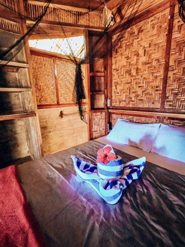 a bowl of fruit sitting on top of a bed at Beachfront Private Bungalow in Libertad