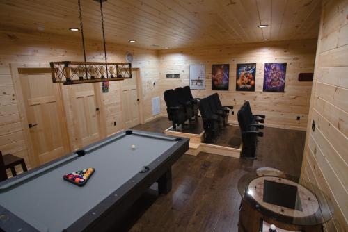 a billiard room with a pool table and chairs at Our Black Bear Lodge in Gatlinburg