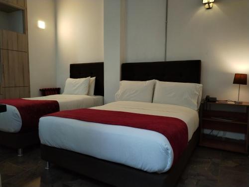 Ένα ή περισσότερα κρεβάτια σε δωμάτιο στο Hotel Capitan Ricaurte