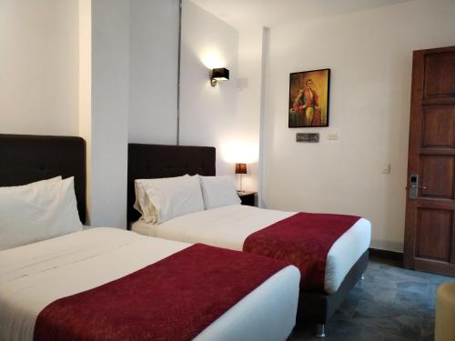 Ένα ή περισσότερα κρεβάτια σε δωμάτιο στο Hotel Capitan Ricaurte