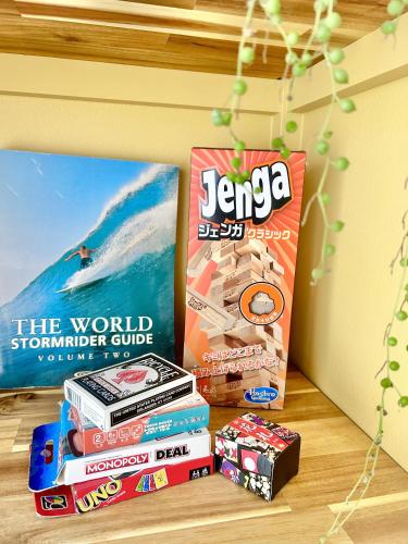 a stack of books sitting on a table next to a stack at Spacious Beach Home 350m to Sotoura Beach in Shimoda