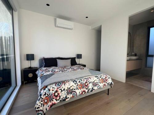a bedroom with a bed with a floral comforter at Luxurious Family Retreat in Blackburn