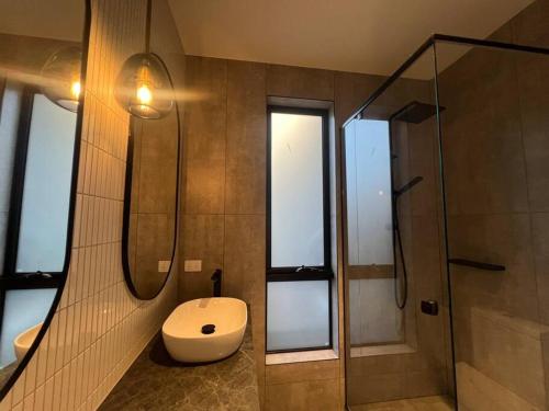 a bathroom with a toilet and a glass shower at Luxurious Family Retreat in Blackburn