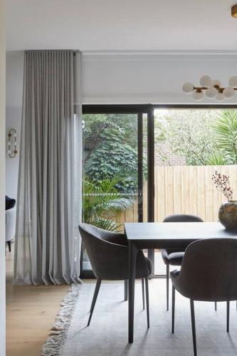 a dining room with a table and chairs and a window at Luxurious Family Retreat in Blackburn