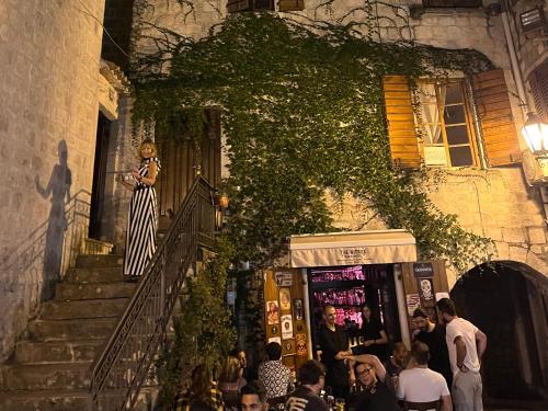 a woman standing on the stairs of a building at La Mia Amore in Kotor