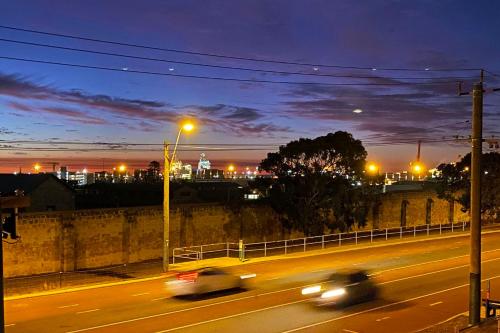 a city at night with cars speeding down a street at Sunsets on Hampton, Fremantle WA in Fremantle