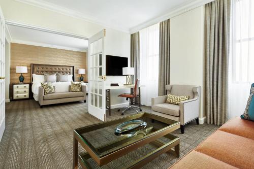 a hotel room with a bed and a living room at The Ritz-Carlton, Philadelphia in Philadelphia