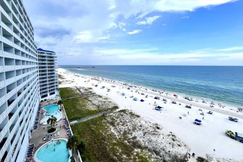 a view of a beach with a building and the ocean at Lighthouse 1017 Condo in Gulf Shores