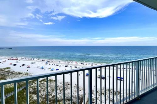 a view of a beach with umbrellas and the ocean at Lighthouse 1017 Condo in Gulf Shores
