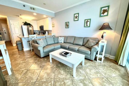 a living room with a couch and a table at Lighthouse 1017 Condo in Gulf Shores