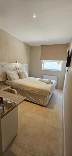 a bedroom with a large bed and a window at MSM Arena Hotel in London