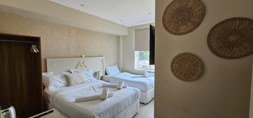 a bedroom with two beds and a window at MSM Arena Hotel in London