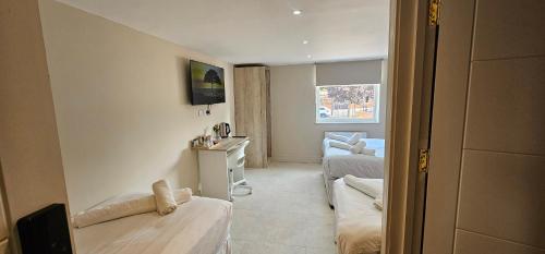 a room with a bedroom with a bed and a desk at MSM Arena Hotel in London