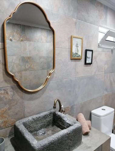 a bathroom with a sink and a mirror at Casa Monte Queimado in Horta