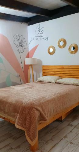 a bedroom with a bed and a wall with drawings on it at Dona Monica in Ituzaingó