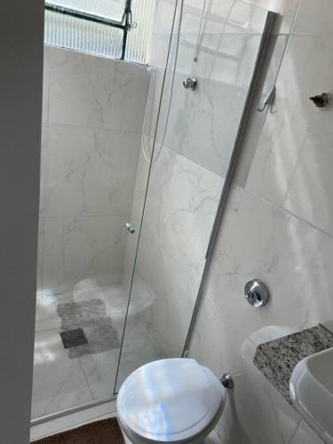 a bathroom with a shower and a toilet and a sink at Exclusive House Barroca in Belo Horizonte