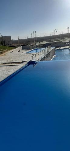 a body of water with a bridge in the background at Mohamed Afifi GAIA Ras El-Hekma - Penthouse 2BR- Families Only in Ras Elhekma