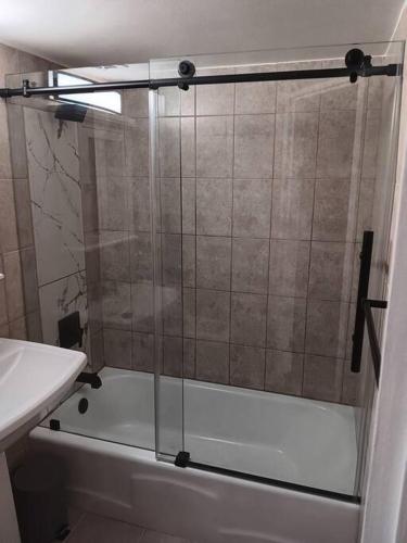 a shower with a glass door in a bathroom at Condo Apartment Near Midway Airport in Chicago
