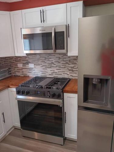 a kitchen with a stainless steel stove and microwave at Condo Apartment Near Midway Airport in Chicago