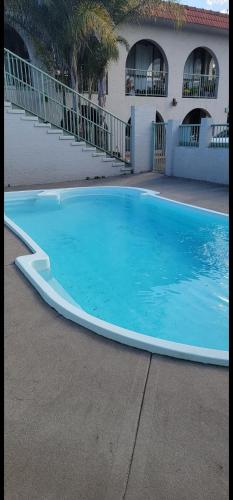 a large blue swimming pool in front of a building at Central 2 Beddy on Beach Road! in Batemans Bay
