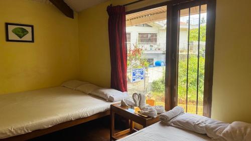 Postel nebo postele na pokoji v ubytování Satya Anand Cottage Pure Veg and Non Alcoholic Hotel