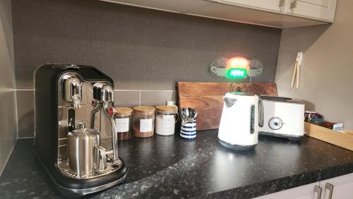 a kitchen counter with a counter top with appliances on it at Huntington Honey in Hamilton