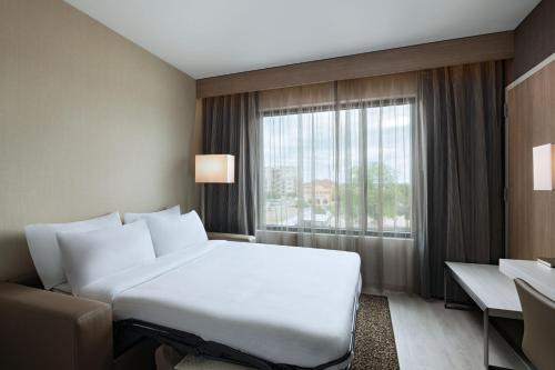 a hotel room with a bed and a window at AC Hotel by Marriott Waco Downtown in Waco