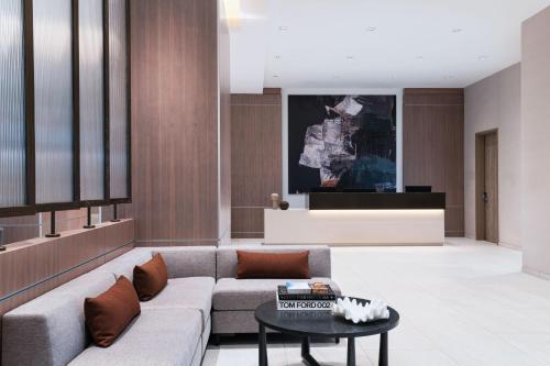 a living room with a couch and a table at AC Hotel by Marriott Waco Downtown in Waco