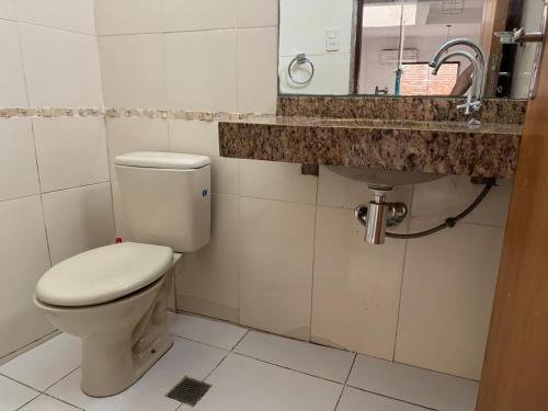 a bathroom with a toilet and a sink at Casa Privada con Piscina y Parking Gratis en Asunción in Asunción