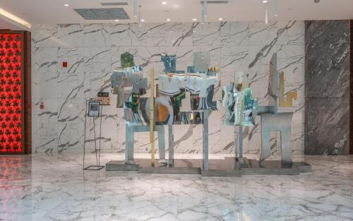 a display of clothes on display in a room with a stone wall at Gran Melia Xi'an in Xi'an