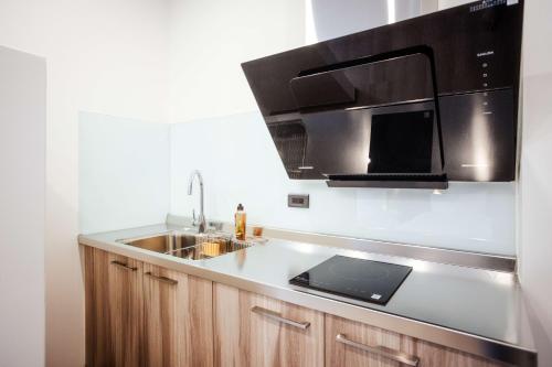 a kitchen with a sink and a microwave at kaori B&B in Chishang