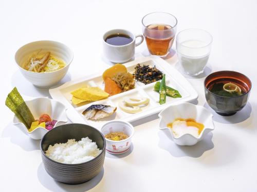 a table topped with different types of food and drinks at APA Hotel Tottori Ekimae Minami in Tottori