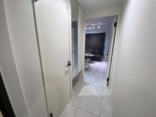 a hallway with a door leading to a living room at EFFECT Kikusui in Sapporo
