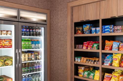 two refrigerators in a room with food and drinks at Fairfield by Marriott Inn & Suites Sioux Center in Sioux Center