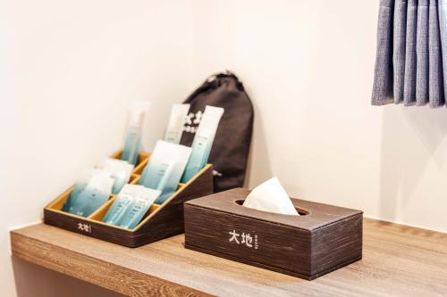 a shelf with two boxes of toothbrushes on it at kaori B&B in Chishang
