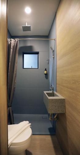 a bathroom with a toilet and a sink at Vivids Hotel in Kuala Lumpur