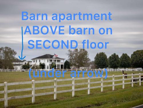 a sign that reads barn apartment above barn on second floor at The Barn Apartment at Parkton Place in Hope Mills