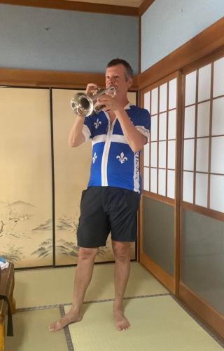 a man drinking a drink from a glass at Guesthouse85BASE in Suo Oshima